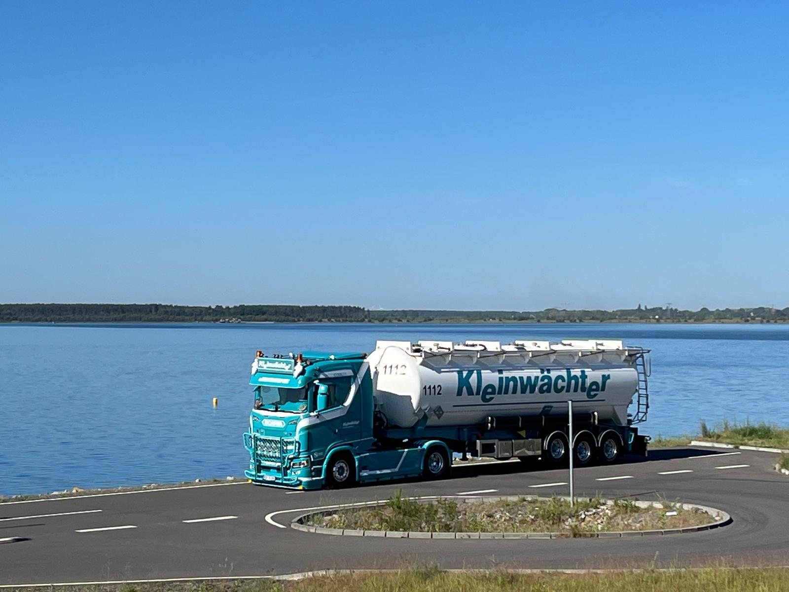 Kleinwächter Silozug auf einer Straße direkt am Wasser